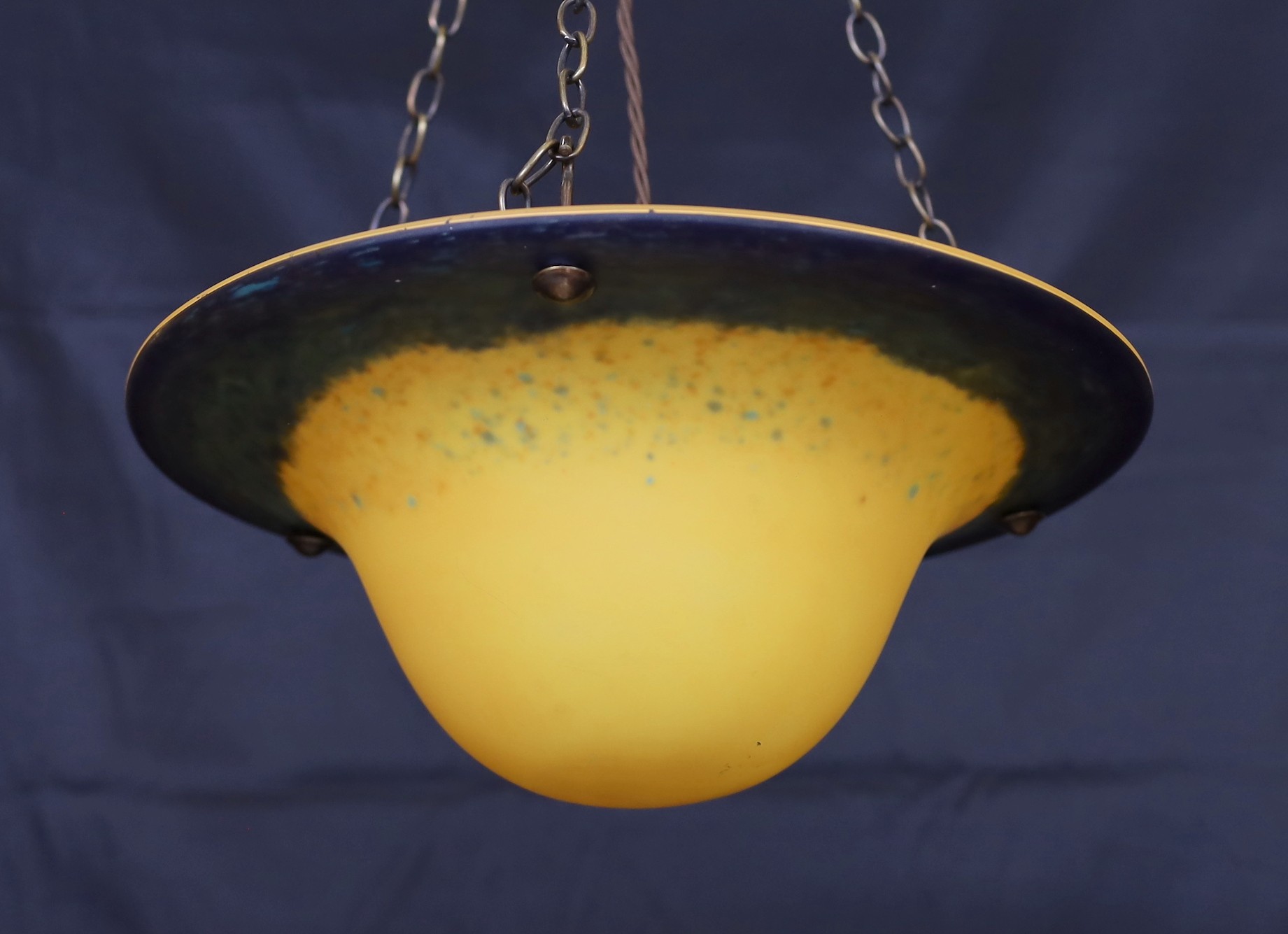 A 1930s style marbled glass light bowl with bronze chains and rose, drop 62cm, width 34cm